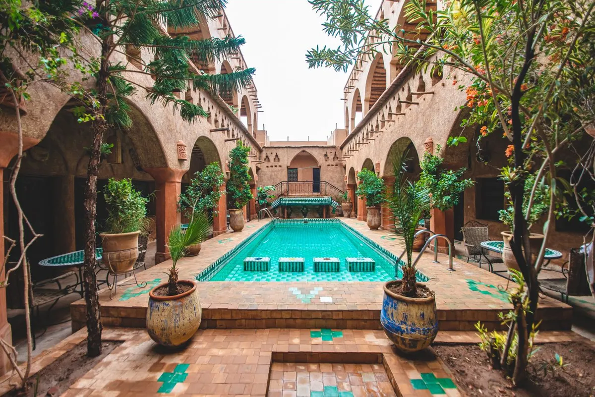 A large courtyard with a pool, surrounded by galleries on two floors