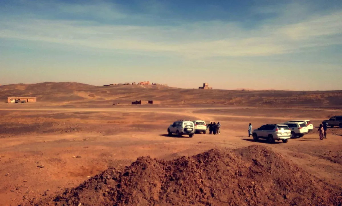 4×4s and their passengers stopped on a desert track