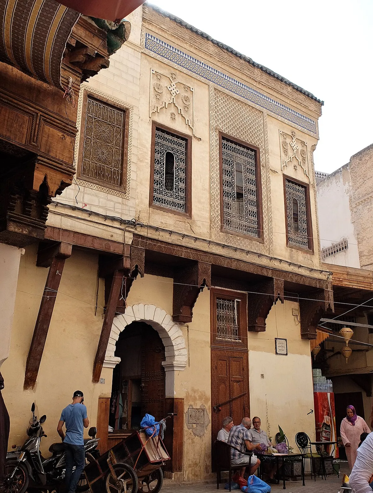 An old house front with wrought iron windows in the Fes medina