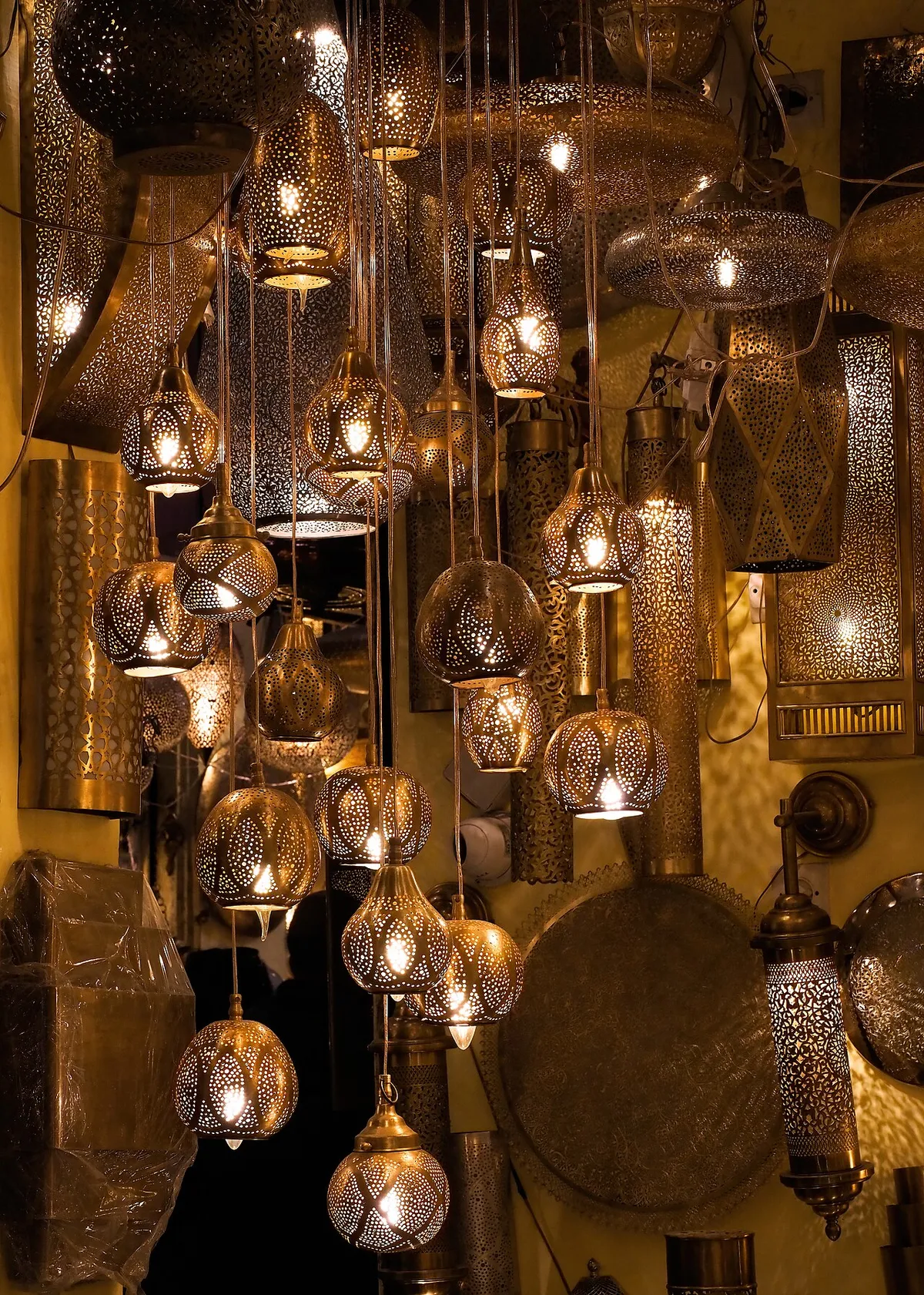 Lit pierced brass lanterns in a shop in the medina