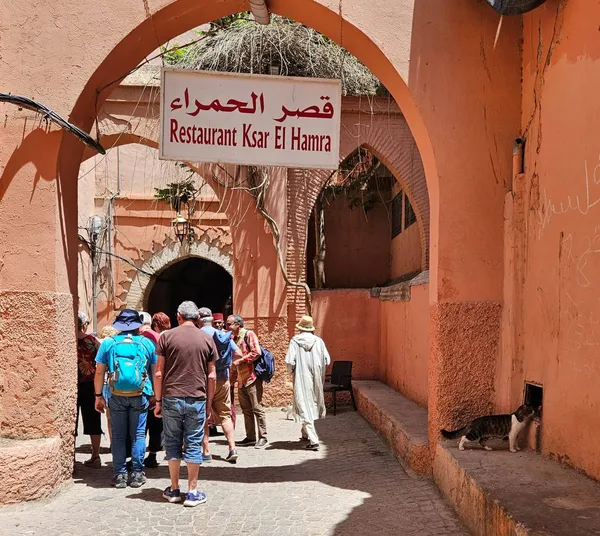 A group of travellers at the entrance of a restaurant in the Marrakech medina